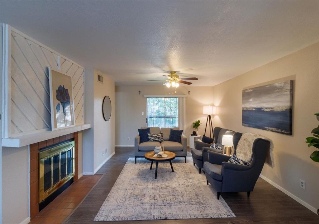 a living room with furniture a rug and a fireplace
