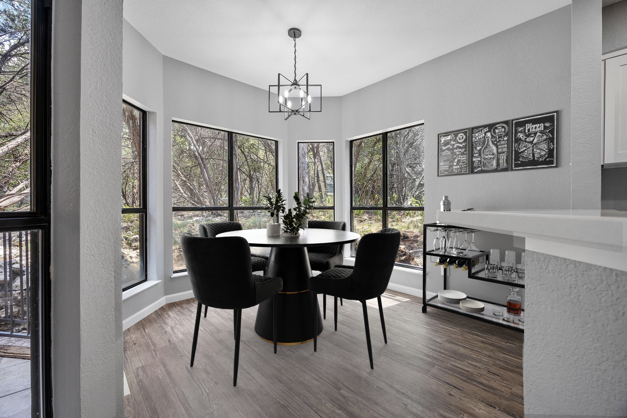 4711 Spicewood Springs Road, Unit 1106 Austin, TX 78759 - Photo 7 of 19 Dining area featuring expansive windows, wood-finish flooring, a contemporary chandelier, and a built-in countertop with an integrated bar area