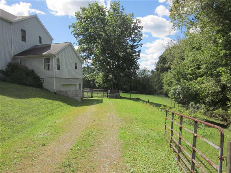 355 Rankin Road Belle Vernon, PA 15012 - Photo 22 of 25 Exterior Back. Gated entrance to the garage offers additional privacy to this home!