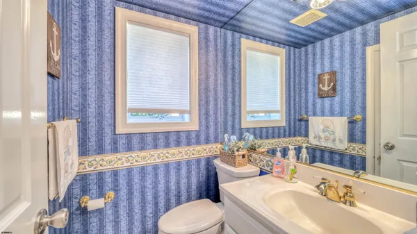 a bathroom with a sink and mirror with toilet