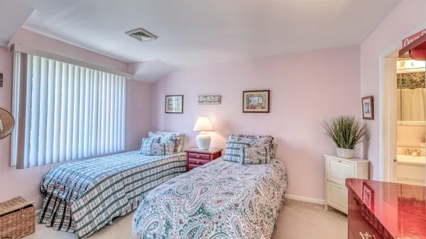 a bedroom with a bed and a potted plant