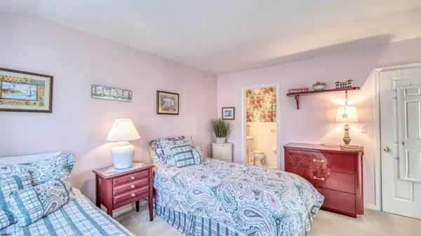 a bedroom with a bed and a dresser in it