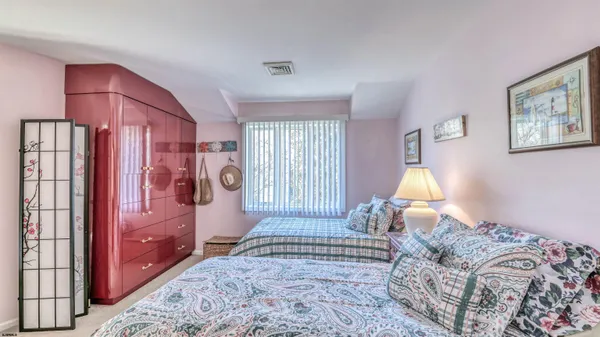 a bedroom with a bed dresser and a window
