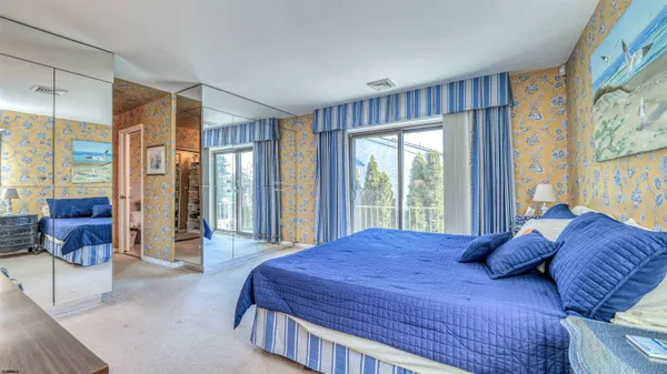 a large bedroom with a large bed and a couch