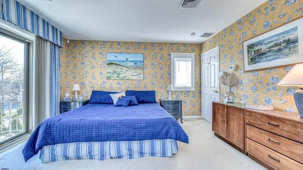 a bedroom with a large bed and a window