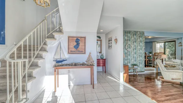 a view of an entryway with kitchen and livingroom