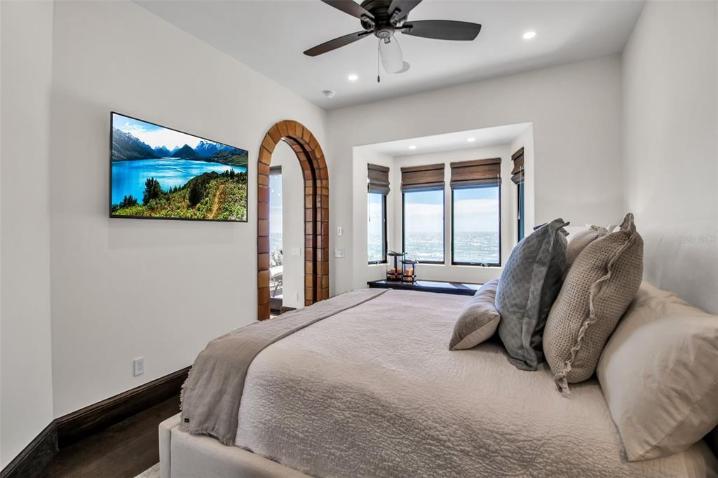 121 North Casey Key Road Osprey, FL 34229 - Photo 31 of 63 a spacious bedroom with a bed and a painting on the wall