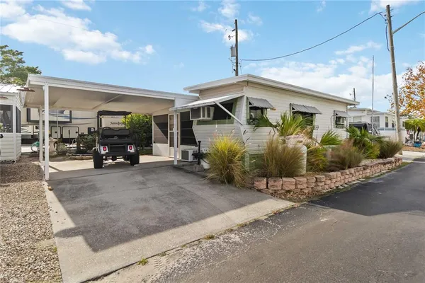 a view of a house with car parked