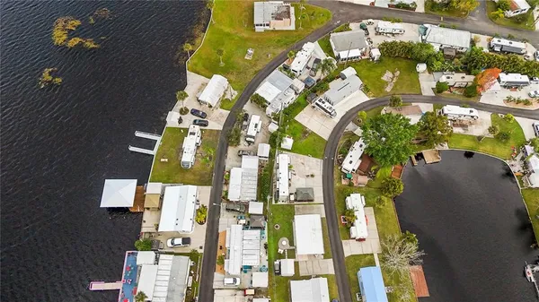 an aerial view of residential houses with yard