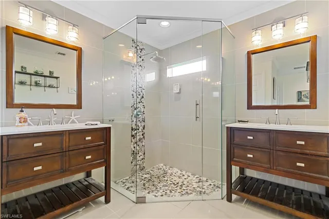 a bathroom with a sink a mirror and a shower