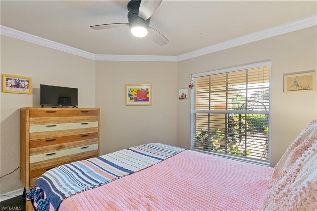 19703 Villa Rosa Loop Estero, FL 33967 - Photo 15 of 29 a bedroom with a bed and a flat screen tv