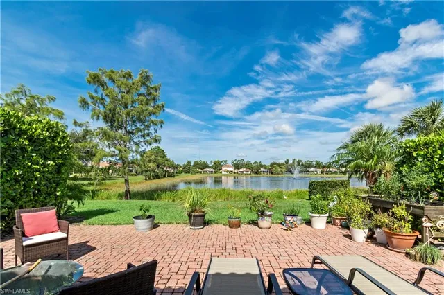 a view of yard with seating area and trees in the background