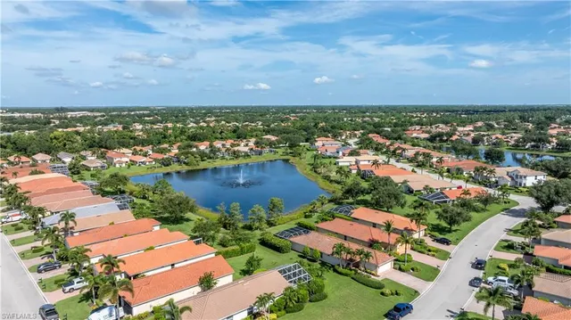 an aerial view of residential houses with outdoor space and trees