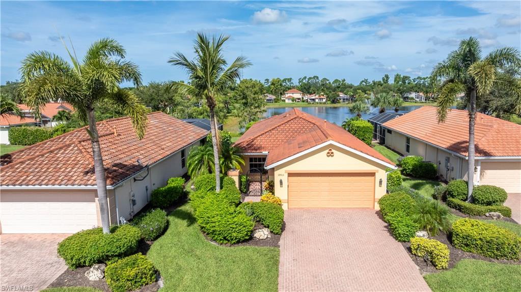 19703 Villa Rosa Loop Estero, FL 33967 - Photo 28 of 29 a front view of a house with a yard and potted plants