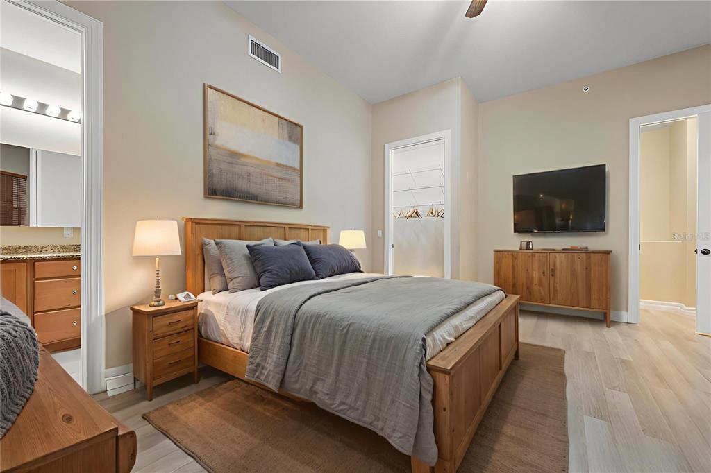 6100 Jessie Harbor Drive, Unit 202 Osprey, FL 34229 - Photo 11 of 83 a bedroom with a bed and a flat screen tv