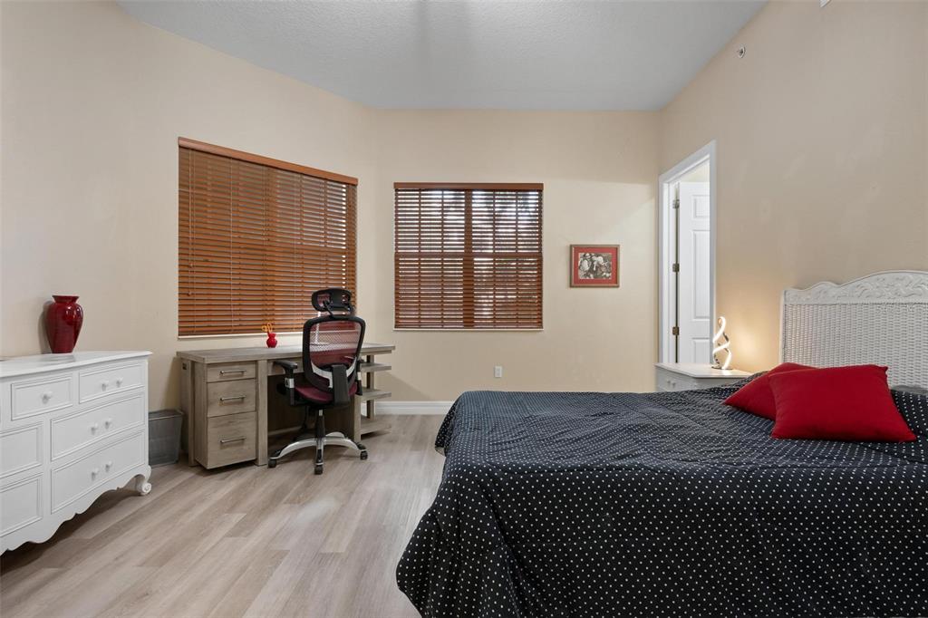 6100 Jessie Harbor Drive, Unit 202 Osprey, FL 34229 - Photo 14 of 83 a bedroom with a bed and a large window