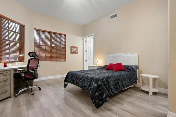 a bedroom with a bed and flat screen tv