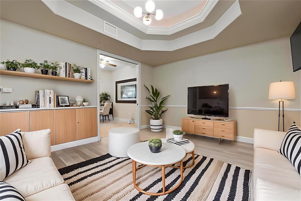 6100 Jessie Harbor Drive, Unit 202 Osprey, FL 34229 - Photo 20 of 83 a living room with furniture and a flat screen tv