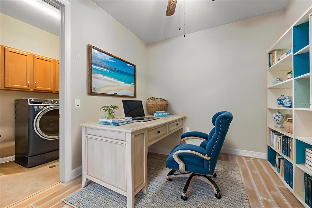 6100 Jessie Harbor Drive, Unit 202 Osprey, FL 34229 - Photo 21 of 83 a view of a workspace with furniture and a book shelf