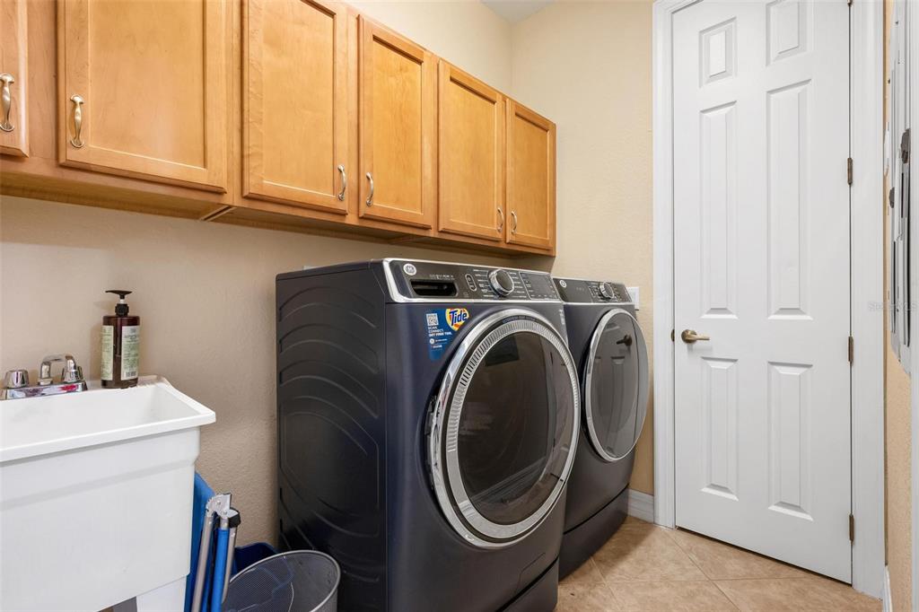 6100 Jessie Harbor Drive, Unit 202 Osprey, FL 34229 - Photo 22 of 83 a utility room with sink dryer and washer