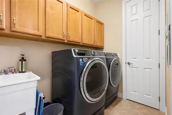 a living room with furniture a flat screen tv and a large window