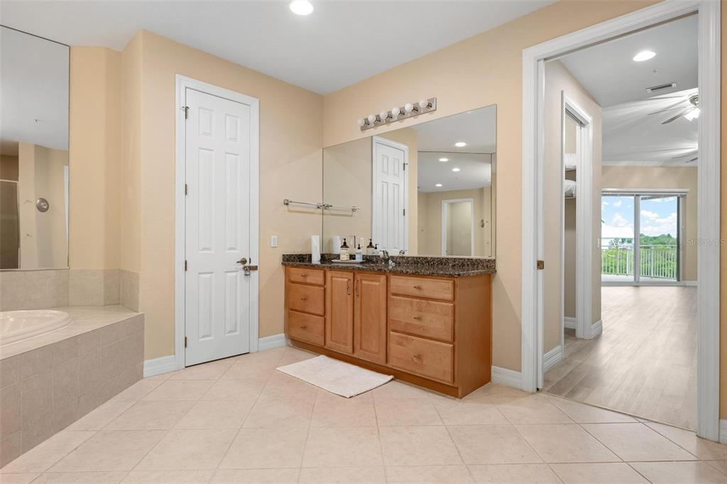 6100 Jessie Harbor Drive, Unit 202 Osprey, FL 34229 - Photo 28 of 83 a spacious bathroom with a tub shower and sink