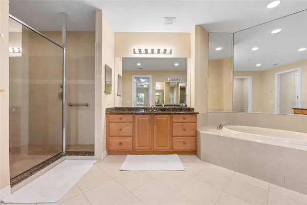 a view of a kitchen with kitchen island a sink stainless steel appliances and cabinets