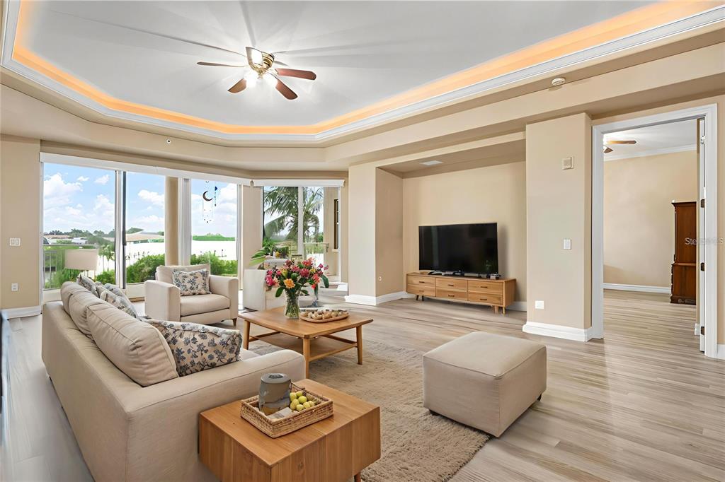 6100 Jessie Harbor Drive, Unit 202 Osprey, FL 34229 - Photo 32 of 83 a living room with furniture and a flat screen tv