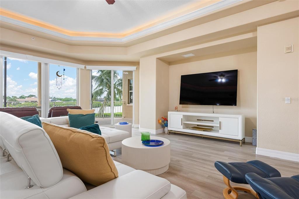 6100 Jessie Harbor Drive, Unit 202 Osprey, FL 34229 - Photo 36 of 83 a living room with furniture and a flat screen tv