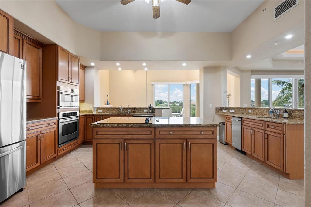 6100 Jessie Harbor Drive, Unit 202 Osprey, FL 34229 - Photo 50 of 83 a kitchen with stainless steel appliances granite countertop a sink and a refrigerator