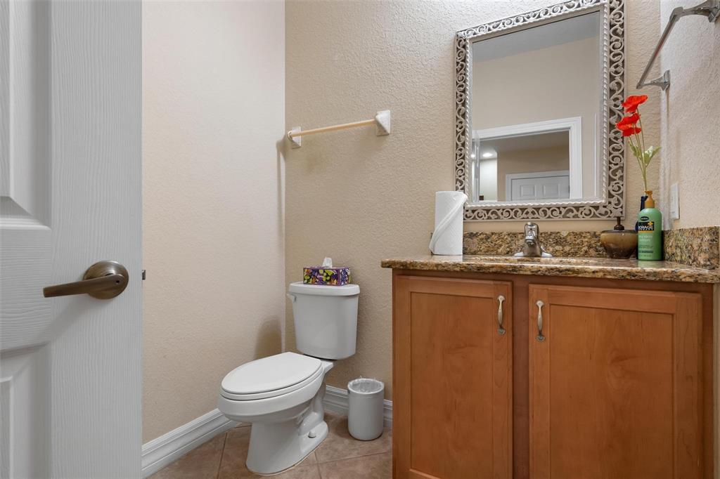 6100 Jessie Harbor Drive, Unit 202 Osprey, FL 34229 - Photo 51 of 83 a bathroom with a granite countertop toilet sink and mirror