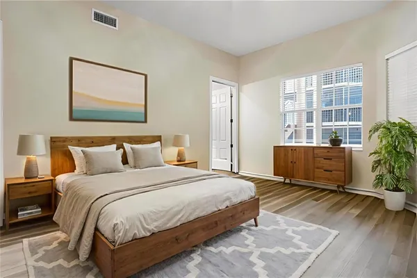 a bedroom with a bed and a large window