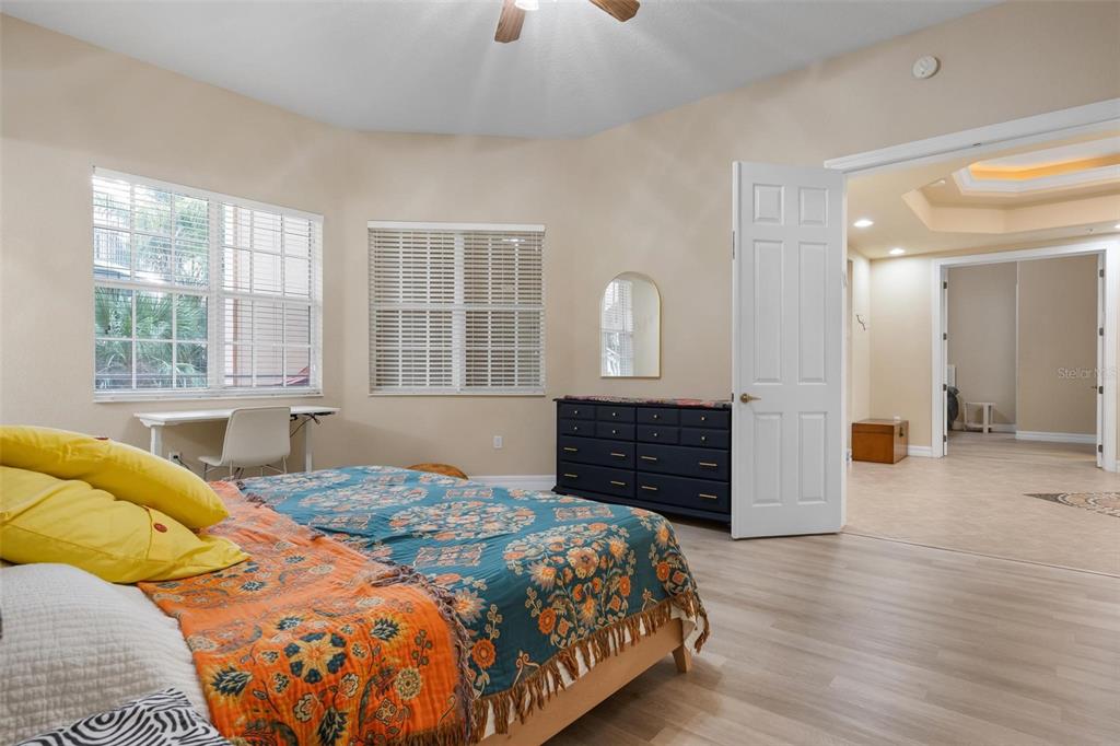 6100 Jessie Harbor Drive, Unit 202 Osprey, FL 34229 - Photo 6 of 83 a bedroom with a bed and wooden floor