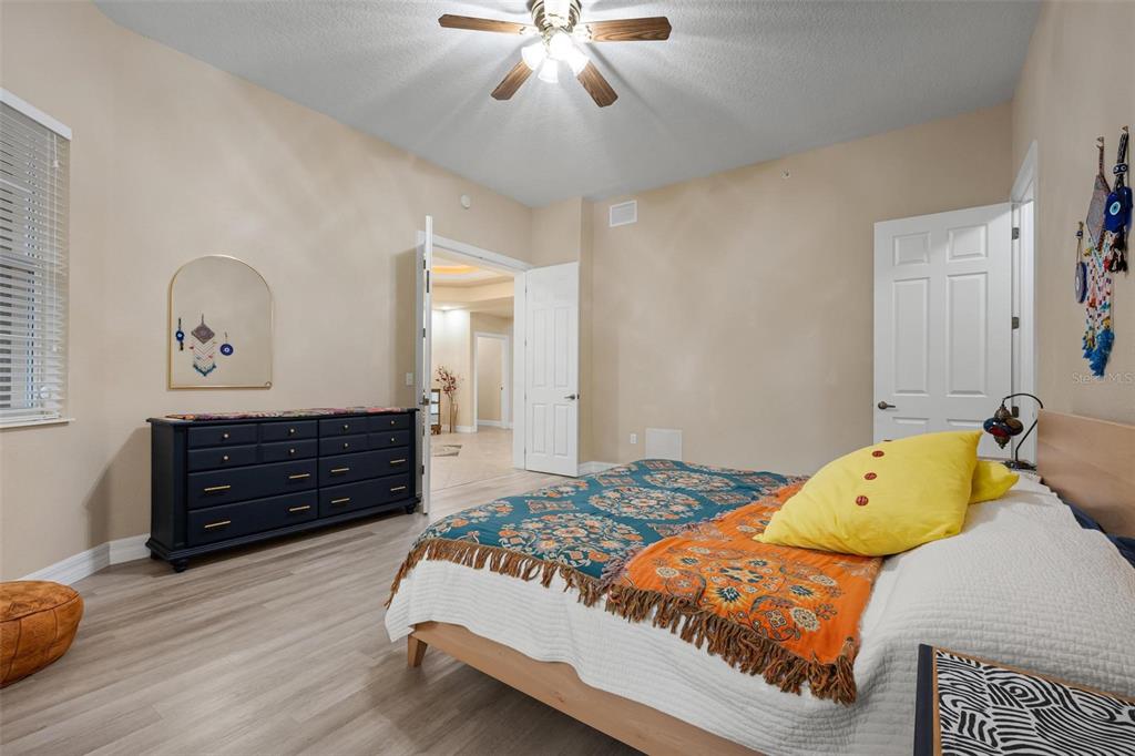 6100 Jessie Harbor Drive, Unit 202 Osprey, FL 34229 - Photo 8 of 83 a bedroom with a bed and wooden floor