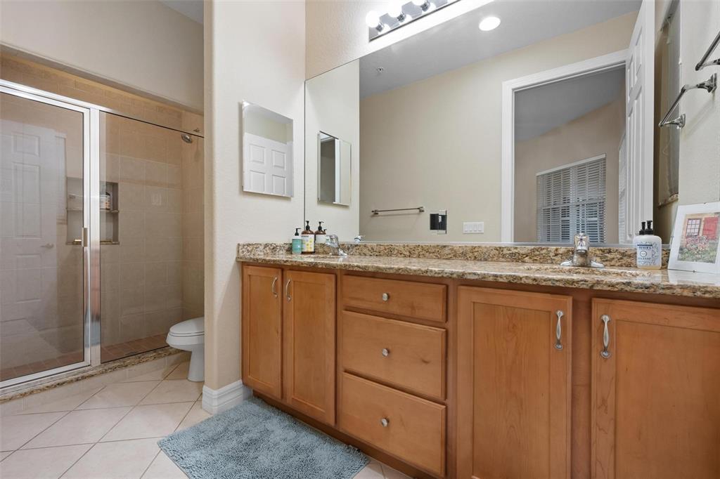 6100 Jessie Harbor Drive, Unit 202 Osprey, FL 34229 - Photo 9 of 83 a bathroom with a granite countertop sink toilet and shower