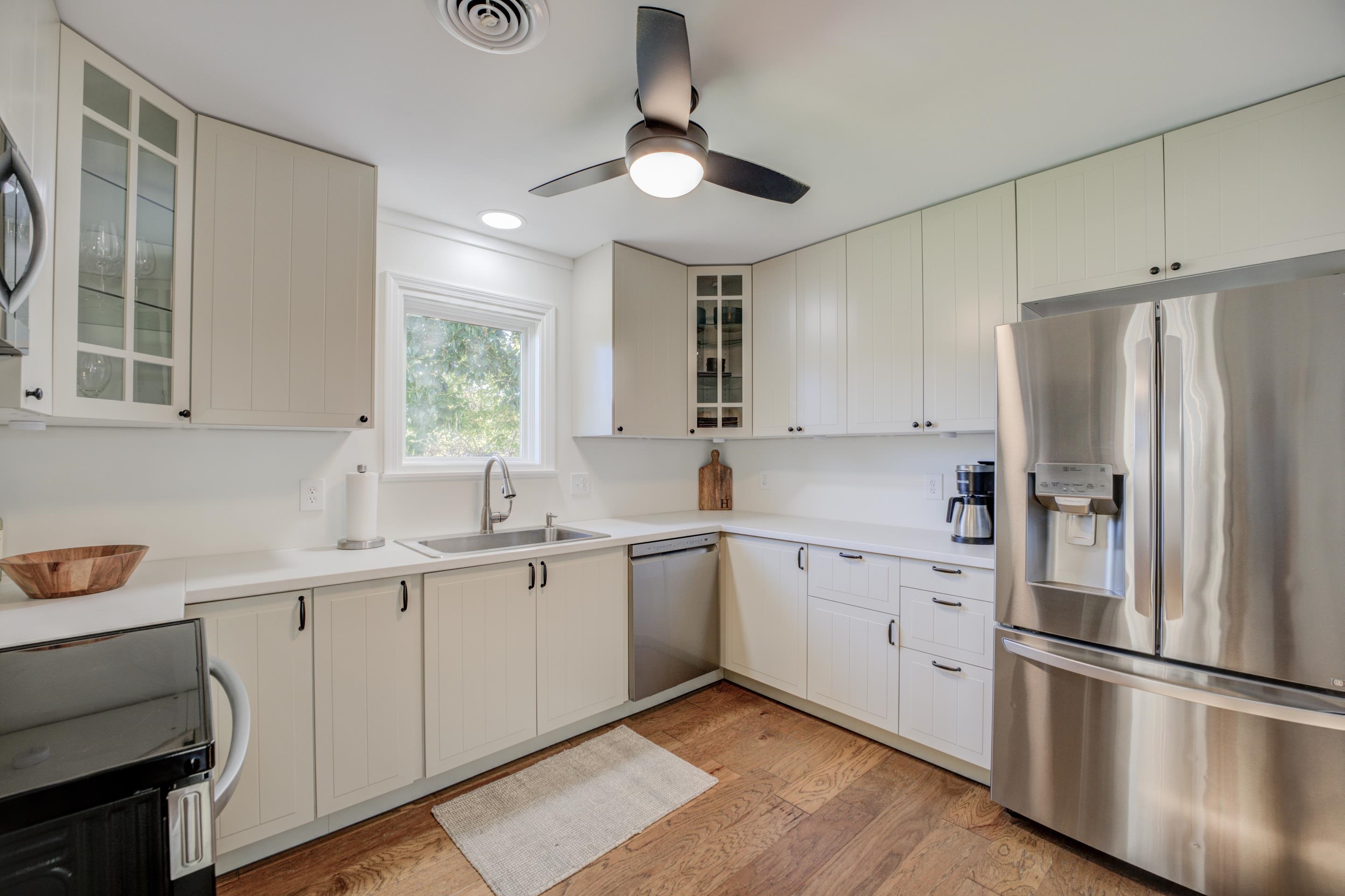 83 Barry White Lane Ripley, TN 38063 - Photo 14 of 37 a kitchen with white cabinets and stainless steel appliances