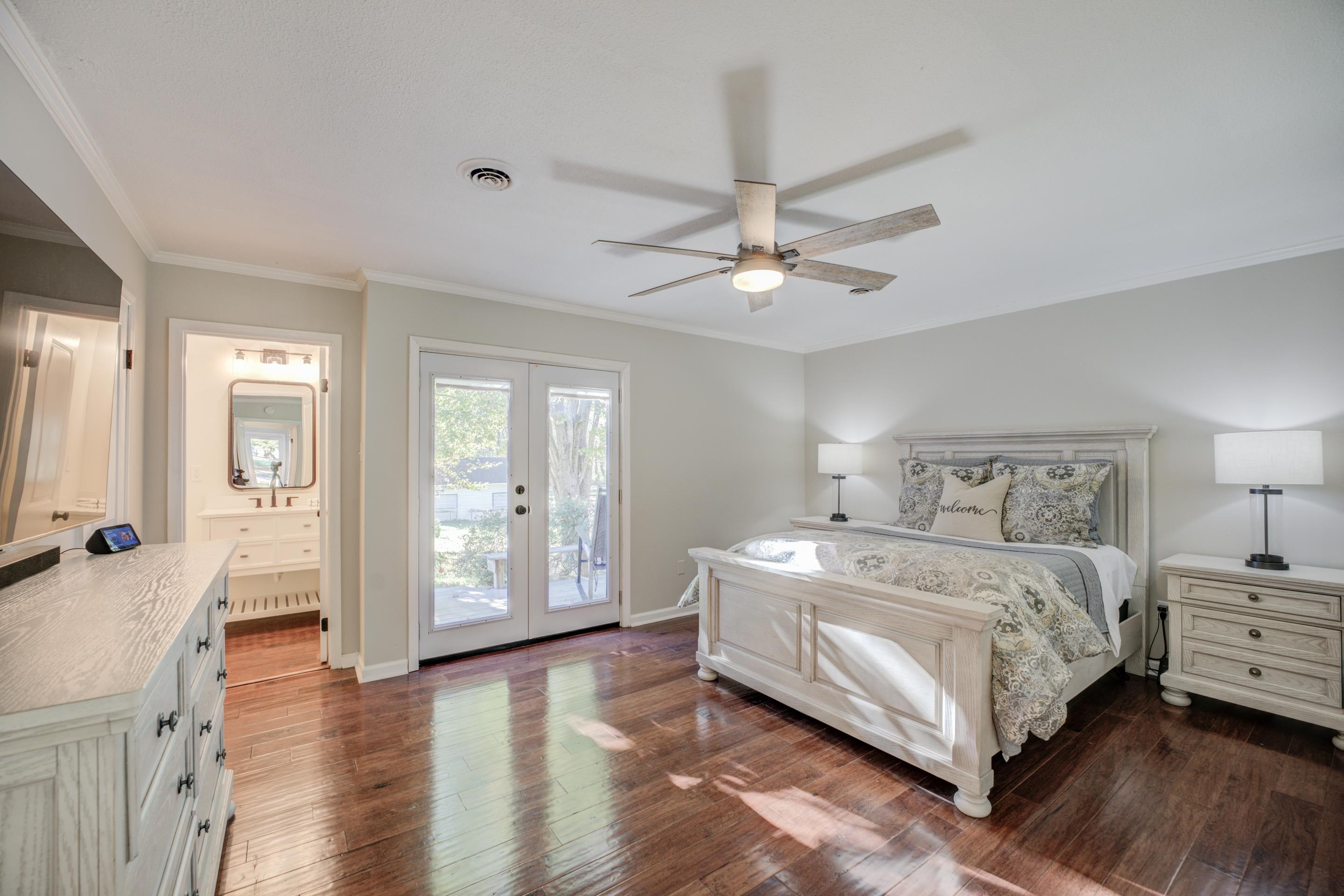 83 Barry White Lane Ripley, TN 38063 - Photo 21 of 37 a spacious bedroom with a large bed and a chandelier