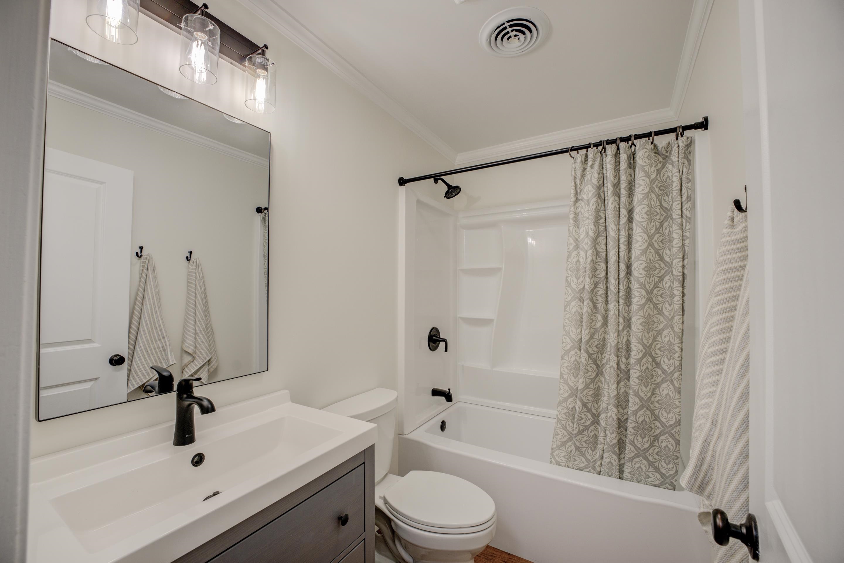 83 Barry White Lane Ripley, TN 38063 - Photo 23 of 37 a bathroom with a sink a toilet and a tub