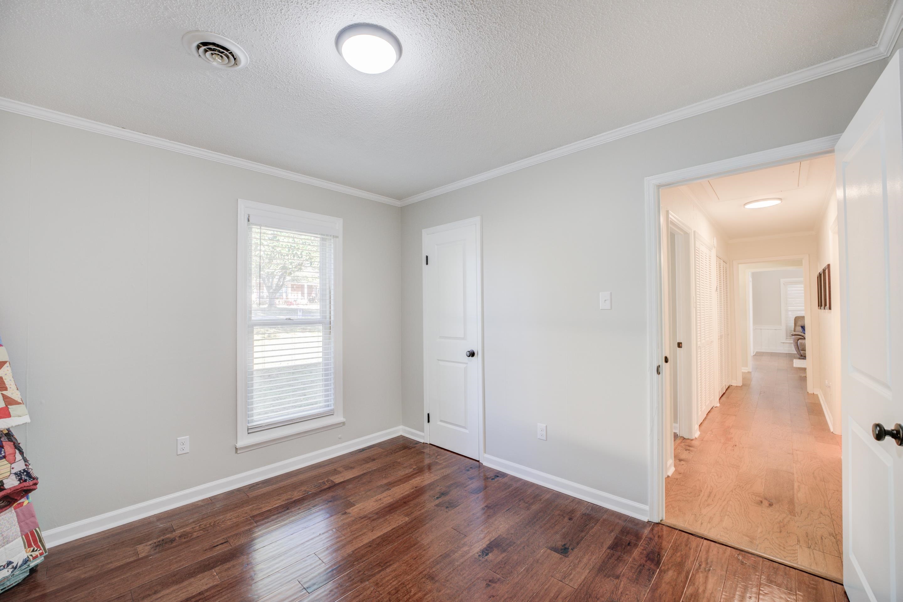 83 Barry White Lane Ripley, TN 38063 - Photo 26 of 37 wooden floor in an empty room with a window
