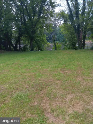 a view of a field with trees in the background