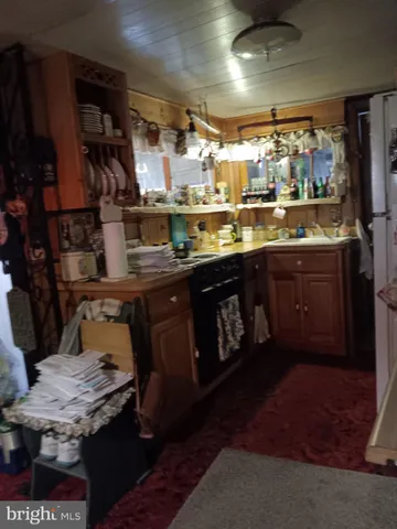 a kitchen with stainless steel appliances granite countertop a table chairs in it and wooden floors