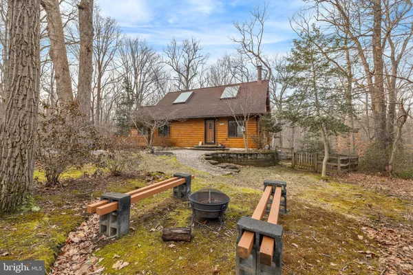 a backyard of a house with barbeque oven and outdoor seating