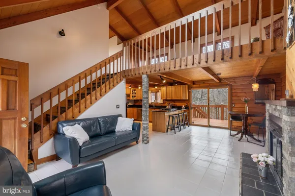 a living room with furniture and wooden floors