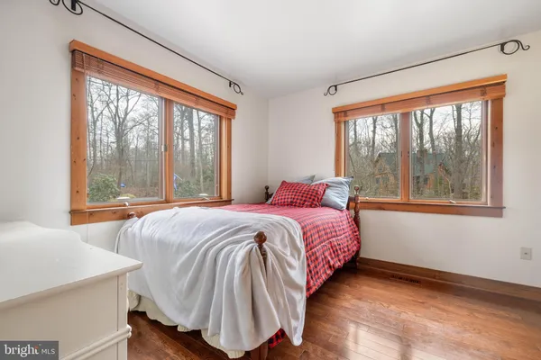 a bedroom with a bed and a large window
