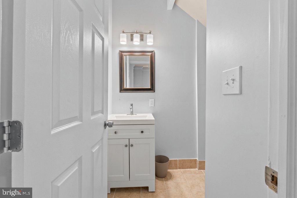 4919 Harford Road Baltimore, MD 21214 - Photo 11 of 48 a bathroom with a sink a light fixture and a mirror