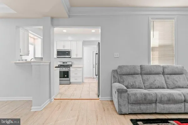 a kitchen with granite countertop a refrigerator and a stove top oven