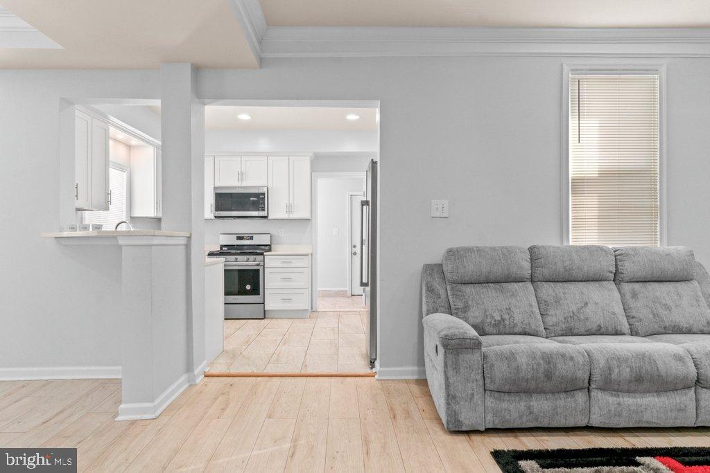 4919 Harford Road Baltimore, MD 21214 - Photo 12 of 48 a living room with furniture and a flat screen tv