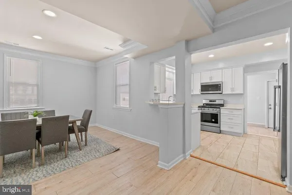 a kitchen with cabinets appliances and a window