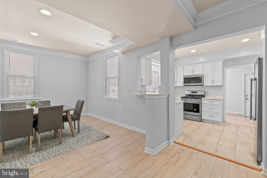4919 Harford Road Baltimore, MD 21214 - Photo 13 of 48 a kitchen with granite countertop a refrigerator and a stove top oven