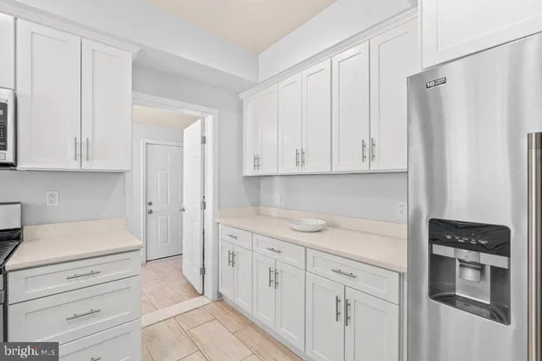 a kitchen with stainless steel appliances granite countertop a sink and a stove